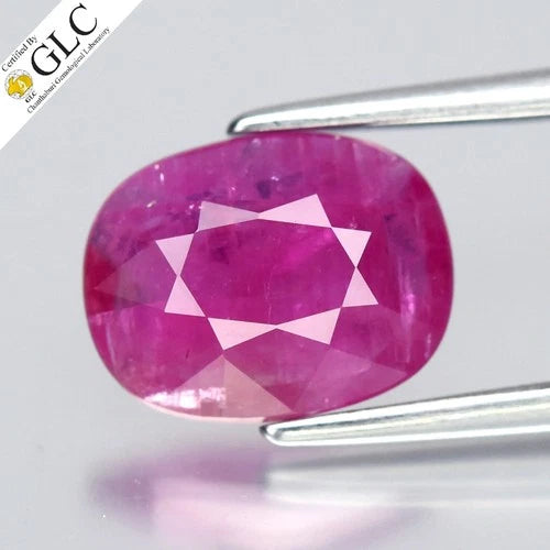GLC-certified 1.95ct cushion natural purplish red ruby with center gem and star-shaped diamond pattern in lab report.
