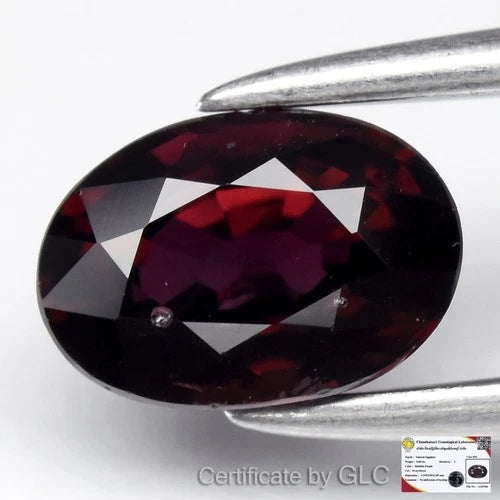 GLC Certified 0.68ct VS oval red-purple sapphire with heating, set in silver tongs, certificate by Gemological Laboratory.