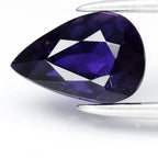 GLC Report 1.13ct VS pear bluish purple sapphire with facet lines, set against a white background.