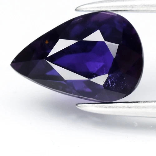 GLC Report 1.13ct VS pear bluish purple sapphire with facet lines, set against a white background.