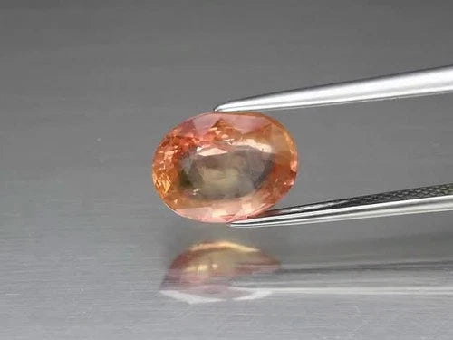 CERTIFICATE Incl.* 3.10ct Oval Pinkish Orange Sapphire (Heated Glass Filling) - Video 1 of 1