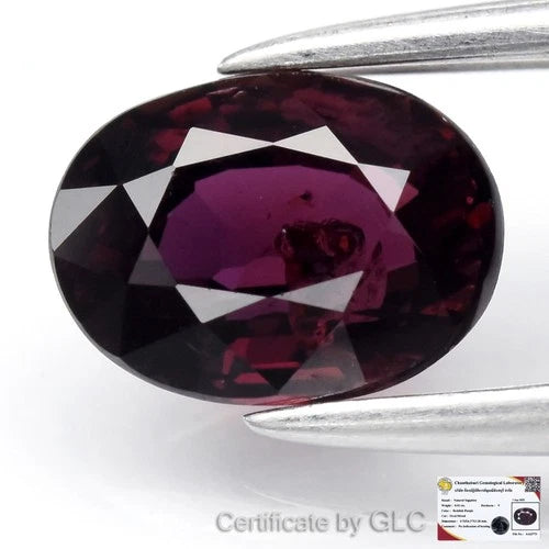 GLC Certified 0.92ct oval reddish purple sapphire with heat-treated Africa label on top, certificate by GLI.