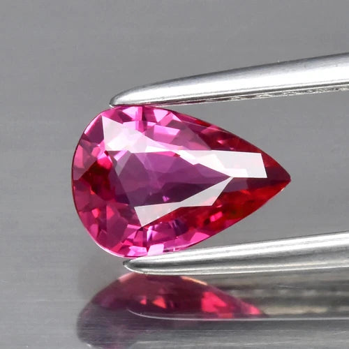 CERTIFICATE Incl.* 0.69ct VVS Pear Natural Unheated Purplish Pink Sapphire on gray background with reflection.