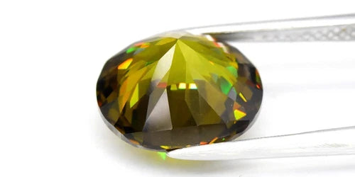 Big 5.80ct VS oval brilliant natural yellow-green garnet with rainbow facets, held by silver-tone tweezers on white background.