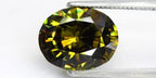 4.56ct VS oval brilliant natural yellowish green demantoid garnet gemstone with rainbow-like color transitions.
