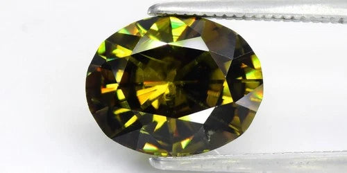 4.56ct VS oval brilliant natural yellowish green demantoid garnet gemstone with rainbow-like color transitions.